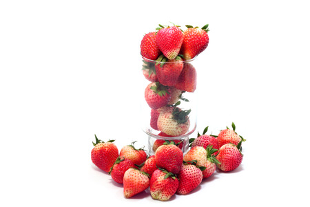 Fresh ripe strawberries in glass on white backgroundの写真素材