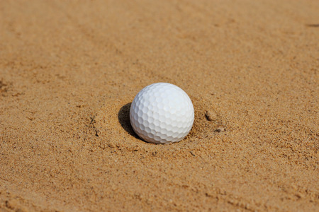Golf ball on sand in bunker  の写真素材
