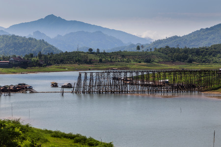 morning at wooden bridge the second longest in the world in thailand の写真素材