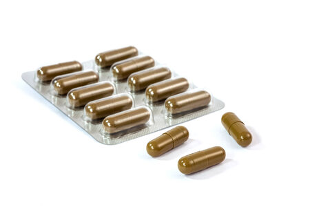 brown medicine capsule on white background の写真素材