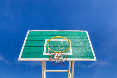 basketball board with  yellow hoop on blue sky backgroundの写真素材