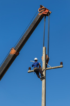 electrician  repairing wire of the power line on electric power poleの写真素材