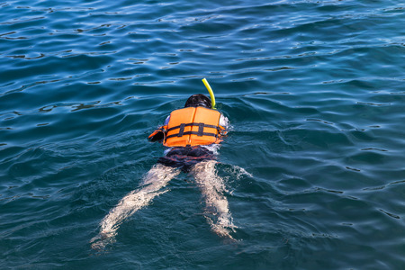 the man snorkeling in andaman sea at phi phi islands, Thailandの写真素材
