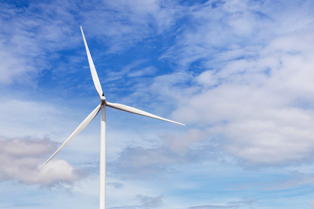 white wind turbines generating electricity in wind power station under blue sky background