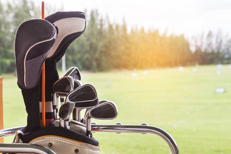 Close up metal golf clubs in bag at golf course driving rangeの写真素材