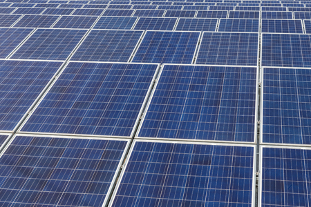 Close up rows array of polycrystalline silicon solar cells or photovoltaics in solar power plant...