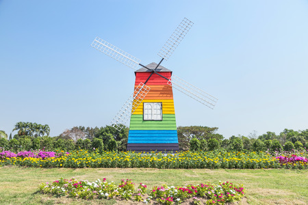 wooden  colorful   windmill in public park on blue skyの写真素材