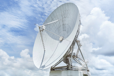 Big large white satellite dishes against blue skyの写真素材
