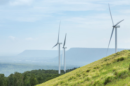 White wind turbines generating electricity in wind power station at Lam Takhong reservoir dam,...