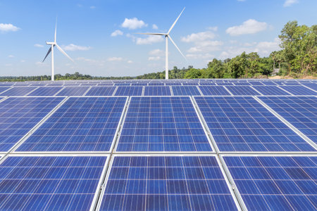 Solar panels with wind turbines generating electricity in hybrid power plant systems station , clean energy power sustainable  energy environmentally friendlyの写真素材