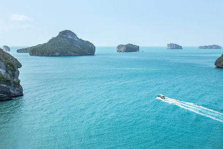 Aerial high landscape view speedboat or motorboat sailing on white wave in the tropical sea at Koh Sam Sao island in Angthong Islands National Marine Park Surat Thani, Thailandの写真素材