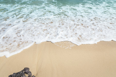 white soft wave rolling splash on the empty tropical beachの写真素材