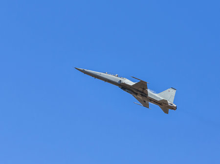 fighter jet military aircraft flying with high speed on blue skyの写真素材