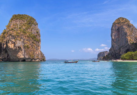 Longtail boat with tourists sailing in crystal clear water andaman sea during Railay beach, Krabi, Thailandの写真素材