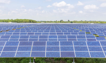 Rows array of polycrystalline silicon solar panels or photovoltaic cells in solar power plant alternative clean energy  environmentally friendly 
on blue skyの写真素材