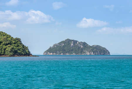 Seascape view of the ripple in turquoise sea with many hills island and many layers mountain background in the morningの写真素材