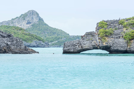 Landscape view natural arch stone curve bridge at Koh Sam Sao island or Tripod Island at Angthong Islands National Marine Park Surat Thani, Thailandの写真素材