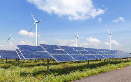 Solar panels with wind turbines generating electricity in hybrid power plant systems station , clean energy power sustainable  energy environmentally friendlyの写真素材