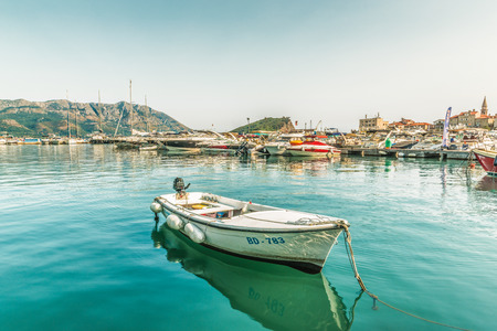 Montenegro, Budva - August 20, 2017: Pier for sailing yachts and boats with a view of the mountains off the coast of Budva, Budva Riviera.のeditorial素材