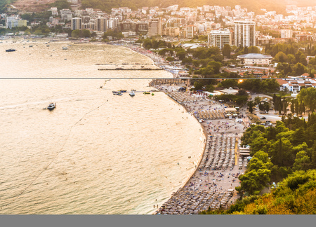 Budva, Montenegro - August 26, 2017: View to the bay, the old town, beaches and hotels on the Budva Riviera in the rays of the sunset. This is the most popular holiday destination in Montenegro.のeditorial素材