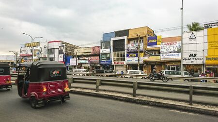 Kalutara, Sri Lanka - January 24, 2017: Fragment of city life - buildings, advertising, city road,...