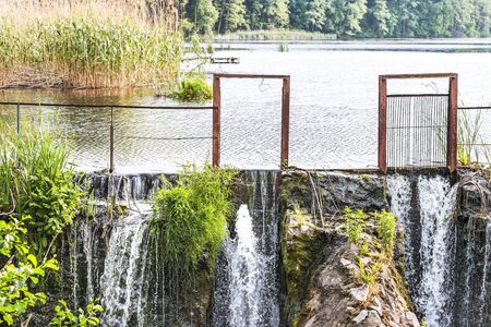 Fragment of a dam with an artificial waterfallの写真素材