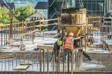 New building under construction and construction site of a residential building. Concrete work is being performed at the site.の写真素材