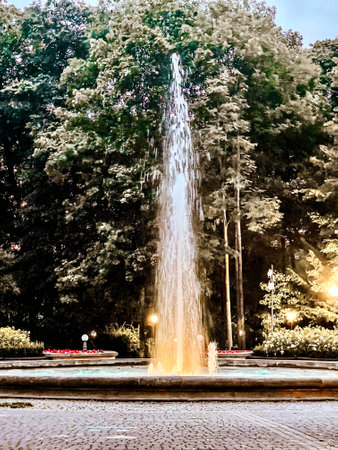 Fountain in the city park at night. Photo in old color image styleの写真素材