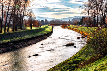 Beautiful landscape with river Ropa and forest at sunset, Gorlice, Poland.