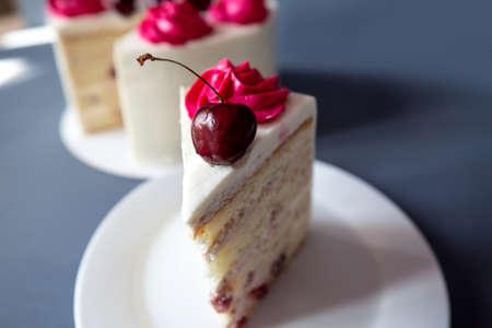 Mouth watering cherry cheesecake macro with fork. Shot on blue backgrond, food