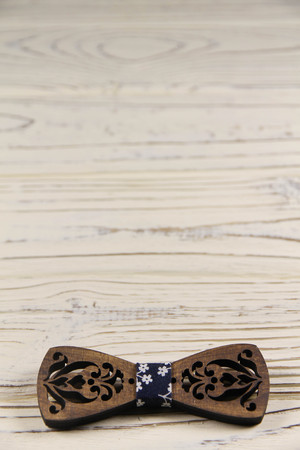 carved bow tie on a wooden backgroundの写真素材