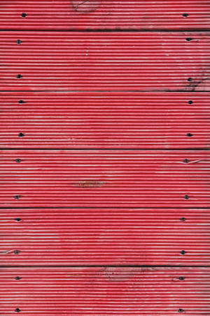 background consisting of red worn planks and nailsの写真素材