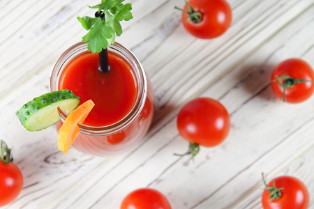 Tomato juice with vegetable decorations on a wooden backgroundの写真素材