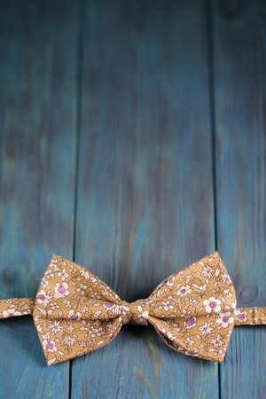 bow tie on a blue wooden backgroundの写真素材