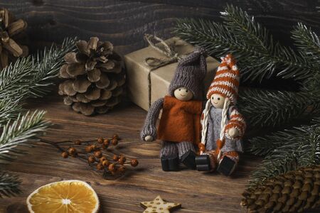 Lovers boy and girl are sitting together next to the spruce. Wintertime