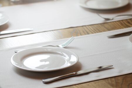 White empty plates without food. The served table.の写真素材