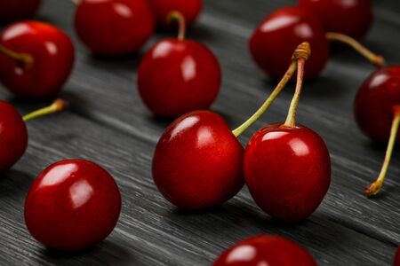 Ripe red cherries on a black background. Loveの写真素材