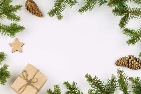 Winter background with gift box, pine cones and fir branches. Christmas.