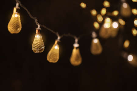 Festive background with a hanging luminous garland.