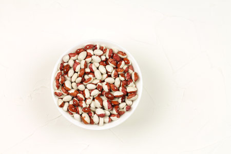Raw spotted beans in a white bowl. Food.の写真素材