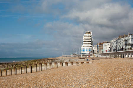 Hastings sea front in a low tide, East Sussex, England, view to the west of the pier, selective focus on the nearest sea groinの写真素材