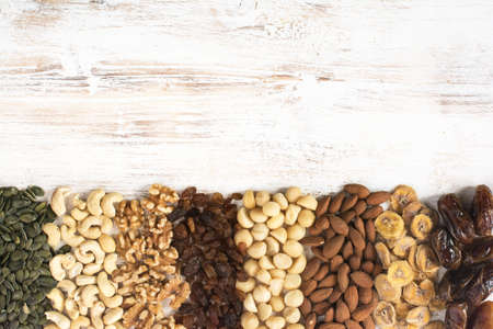 Rows of different nuts, top view, space for text