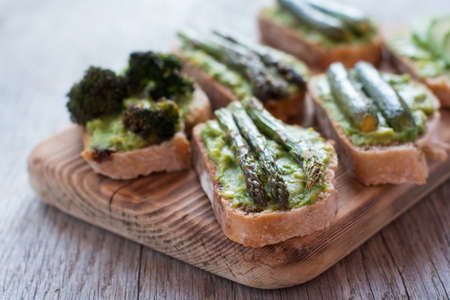 Green vegetarian sandwiches selection made with avocado, courgette, asparagus, broccoliの写真素材