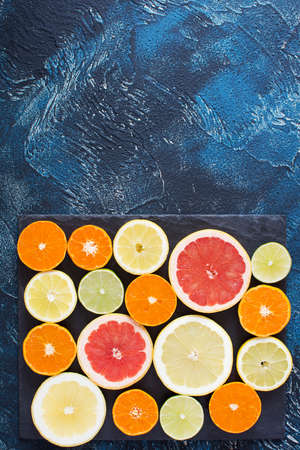 Cut citrus fruits on the dark blue backgroundの写真素材