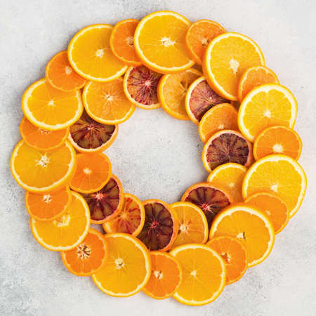 Oranges, blood oranges, tangerine slices in circleの写真素材