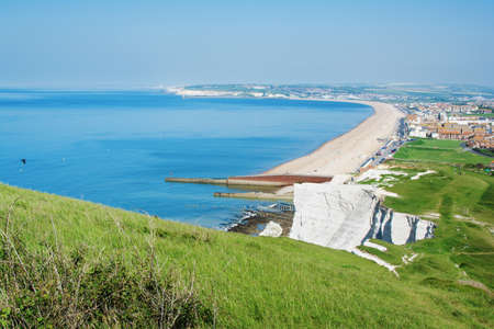 Seaford Head, East Sussex, England. View of the white chalk cliffs, part of Seven Sisters National park and the town of Seaford in the morning, selective focusの写真素材