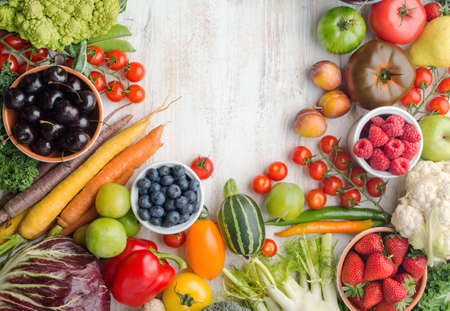 Fresh farm produce, summer fruits vegetables berries, cherries strawberries raspberries broccoli cauliflower squash tomatoes carrots beans, pepper, copy space, top view, selective focusの写真素材