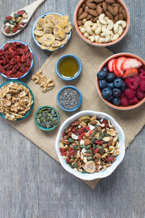 Paleo style breakfast: gluten free and oat free muesli made with nuts, dried berries and fruits, top...