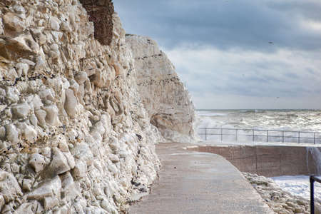 View of eastern part of Seaford beach in a stormy weather, East Sussex. England, cliffs, sea and cloudy sky, selective focusの写真素材