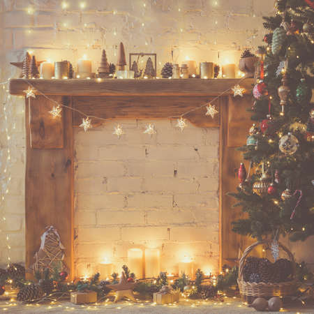 Beautiful Christmas backgroun, decorated fireplace with solid wood mantelpiece, lit up Christmas...